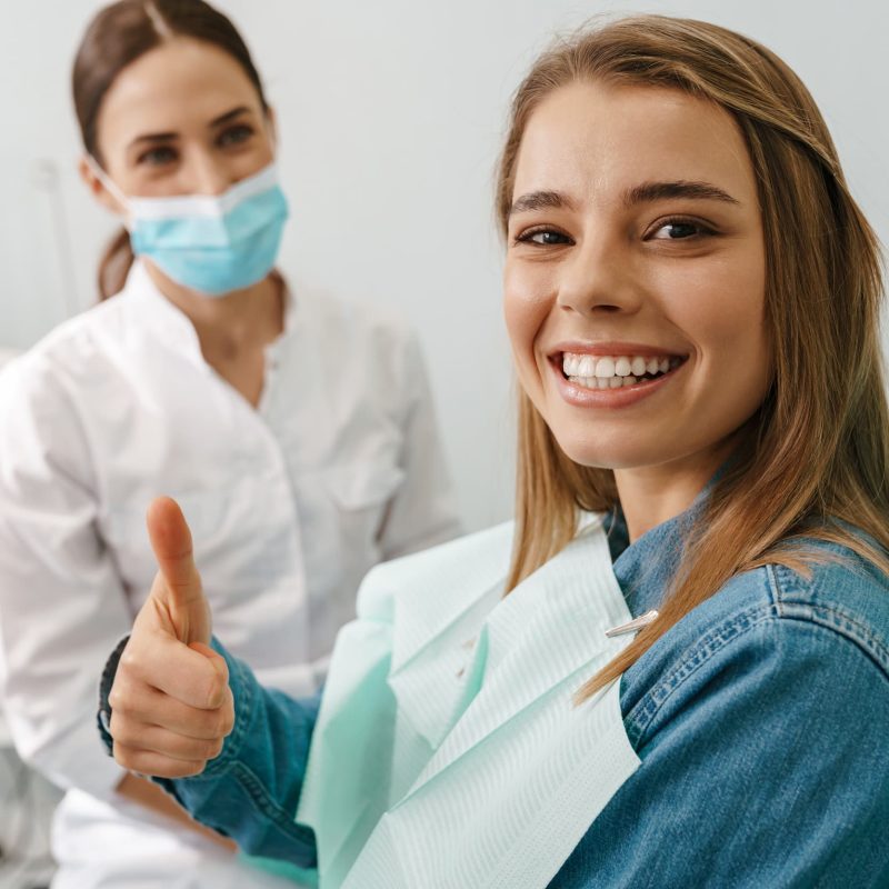 Happy patient giving thumbs up in dental office