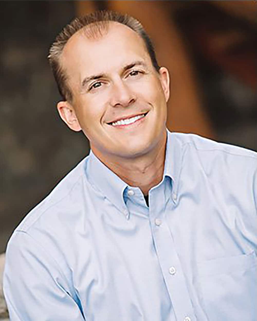 Smiling man in blue shirt