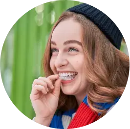 Cheerful woman laughing, wearing colorful winter attire