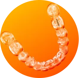 Clear dental aligner on orange background